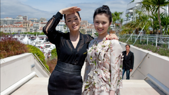 Gong Li and Zhang Huiwen at a premiere for "Coming Home"