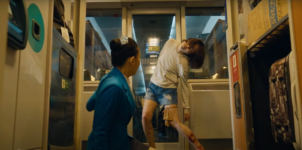 Female train attendant confronting zombie girl.