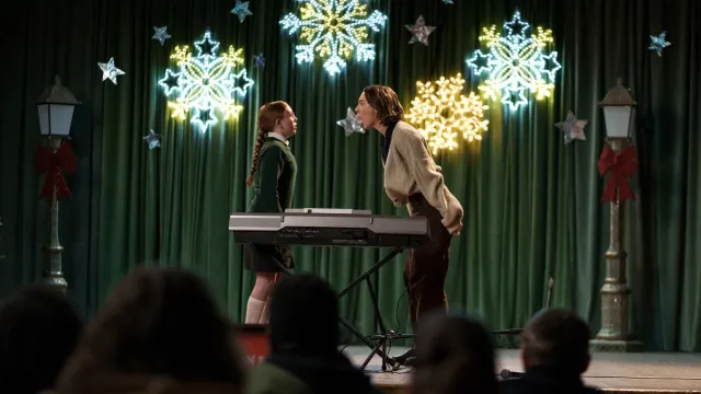 Maria (Ronan) yells at Paulina on a stage, in front of parents and teachers.